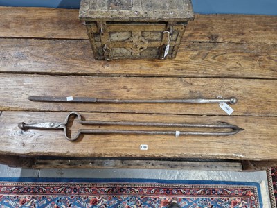 Lot 1569 - A massive pair of iron fire tongs together...
