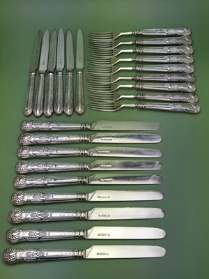 Lot 1614 - A set of nine silver fruit knives and forks by...