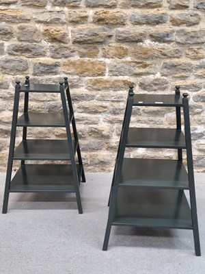 Lot 1633 - A pair of dark green painted etageres, each...