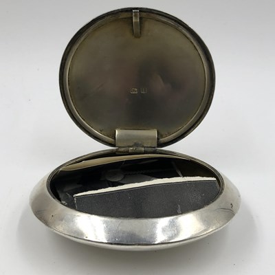 Lot 1031 - A hallmarked silver pocket tobacco box with a...