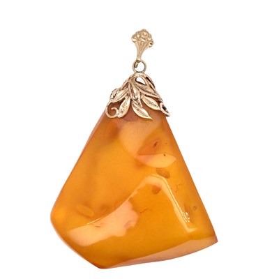 Lot 1032 - A large amber pendant of irregular triangular...