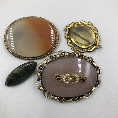 Lot 1049 - A collection of four vintage brooches. Three...