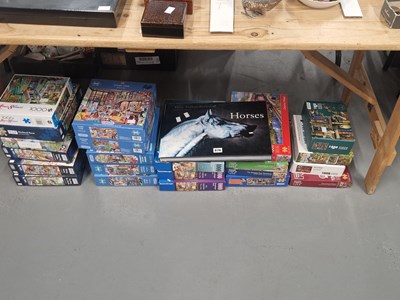 Lot 876 - Boxes of jigsaw puzzles together with a book...