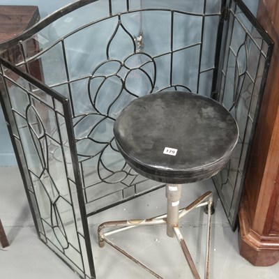 Lot 179 - A glazed firescreen and a stool.