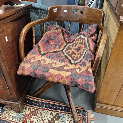 Lot 214 - An antique oak swivel office chair