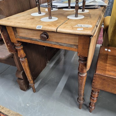 Lot 220 - An antique pine Pembroke table. H 74 W 106 D...
