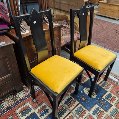 Lot 257 - A set of four gothic-style ebonised dining...
