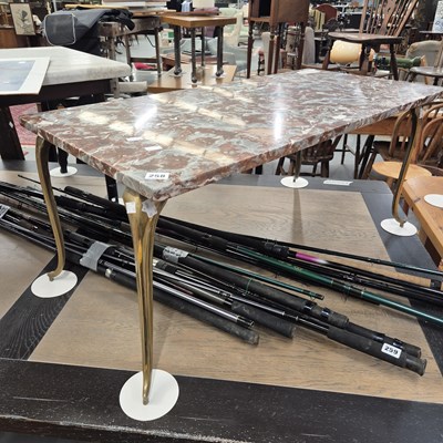 Lot 258 - A marble topped, brass framed coffee table. H...