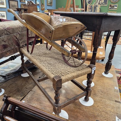 Lot 267 - A vintage child's wheelbarrow and a stool.