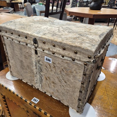 Lot 286 - An antique hide covered travelling box. H 30 W...