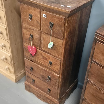 Lot 315 - An eastern hardwood multi drawer chest. H 109...