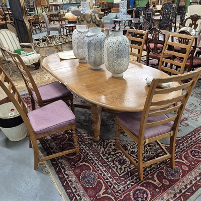 Lot 350 - An Ercol dining table and six ladder-back...