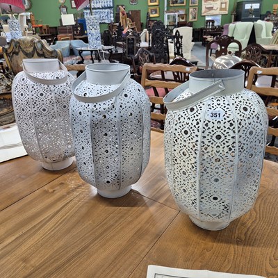 Lot 351 - Three pierced metal candle lanterns.