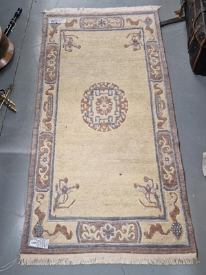 Lot 1168 - A Tibetan rug of Chinese design 184cm x 92cm