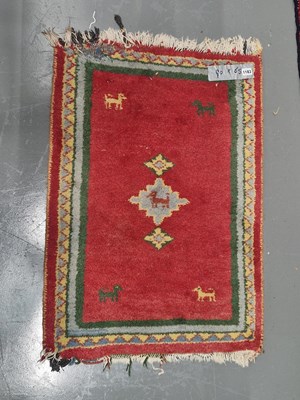 Lot 1183 - A Tribal oriental mat 90cm x 65cm