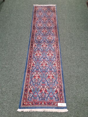 Lot 1198 - A finely woven Persian runner of traditional...