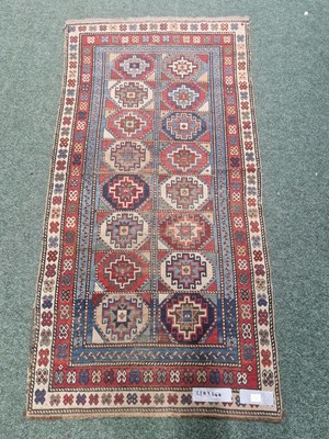 Lot 1236 - An antique Caucasian rug of distinctive design...
