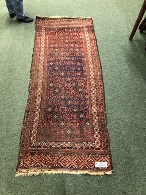 Lot 1238 - An antique Belouch runner 256 x 98 cm