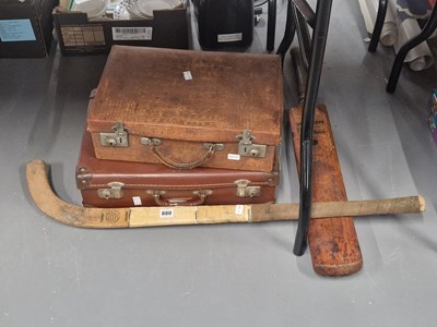 Lot 880 - A cricket bat, a hockey stick and two leather...