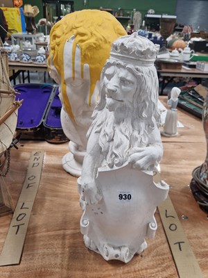 Lot 930 - A composition crowned lion holding a shield...
