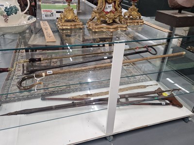 Lot 949 - A brass hook ended winding handle, an iron...