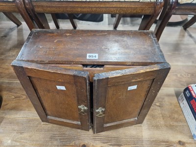 Lot 954 - A stained wood medicine cabinet with some...