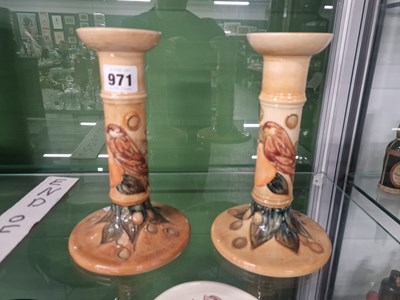 Lot 971 - A pair of Walter Moorcroft candlesticks slip...