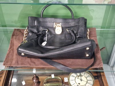 Lot 973 - A Michael Kors black leather handbag with dust...