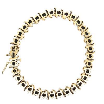 Lot 1119 - A garnet set line bracelet, stamped 14k,...