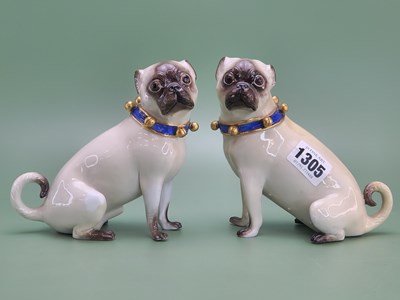 Lot 1305 - A pair of Meissen seated pugs facing each...