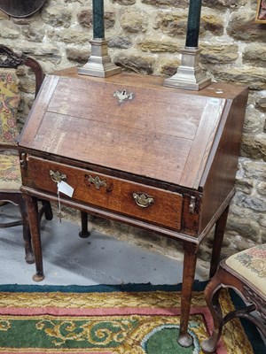 Lot 1308 - A George III oak bureau with a single drawer...