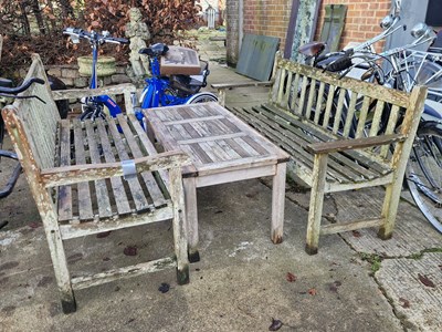 Lot 1266 - Two similar hardwood garden benches and a low...