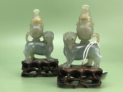 Lot 1220 - A pair of Chinese sea green hardstone carvings...