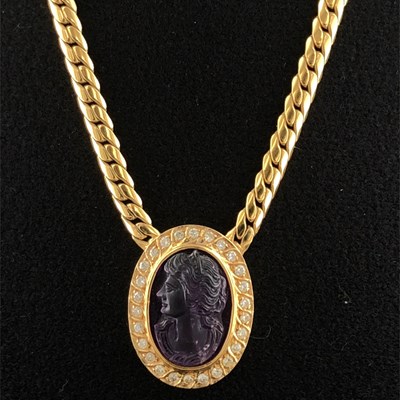 Lot 1001 - An oval amethyst intaglio carved as a...