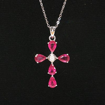 Lot 1022 - A 9ct white gold pear-shaped ruby and diamond...