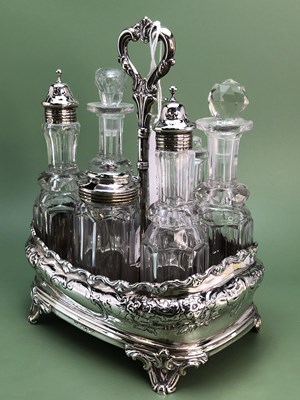 Lot 1228 - A Victorian seven bottle cruet held in a...
