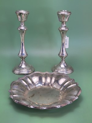 Lot 1275 - A pair of silver candlesticks by Bushell & Co.,...