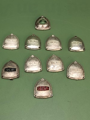 Lot 1279 - Ten silver Ducati shield shaped logos, 142g