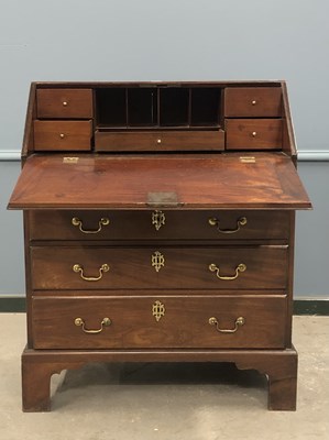 Lot 1296 - A George III mahogany bureau, the fall above...