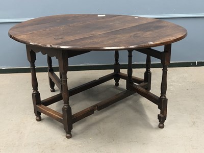 Lot 1299 - A 19th century oak oval drop flap table with a...