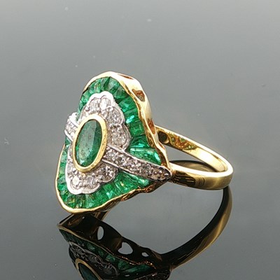 Lot 1035 - An 18ct yellow gold emerald and diamond dress...