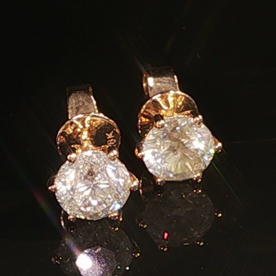 Lot 1036 - A pair of 18ct rose gold round brilliant cut...