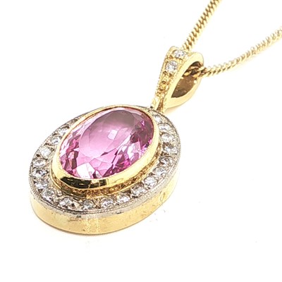 Lot 1052 - An 18ct yellow gold oval pendant set with a...