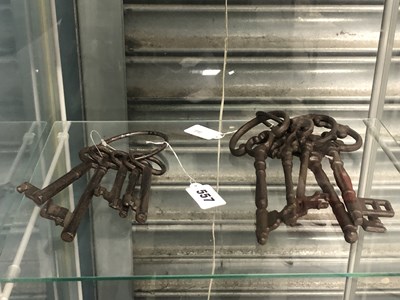 Lot 557 - Two rings of vintage iron keys
