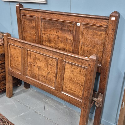 Lot 47 - A vintage oak double bed with panelled foot...