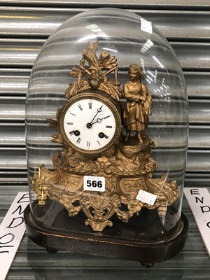 Lot 566 - A striking clock in a gilt metal case under a...
