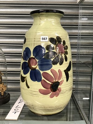 Lot 567 - A green gound vase painted with three flowers