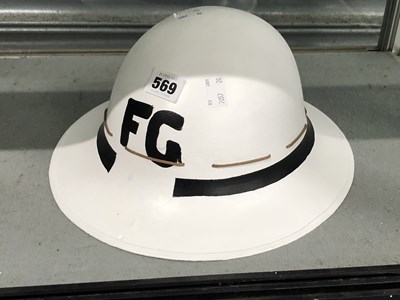 Lot 569 - A white metal helmet initialled FG in black