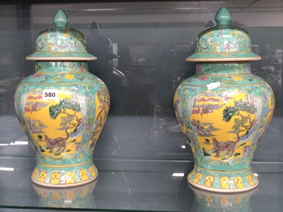 Lot 580 - A pair of Chinese turquoise ground baluster...