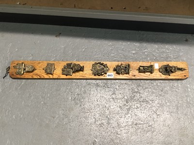 Lot 663 - An oak panel mounted with seven brass souvenir...